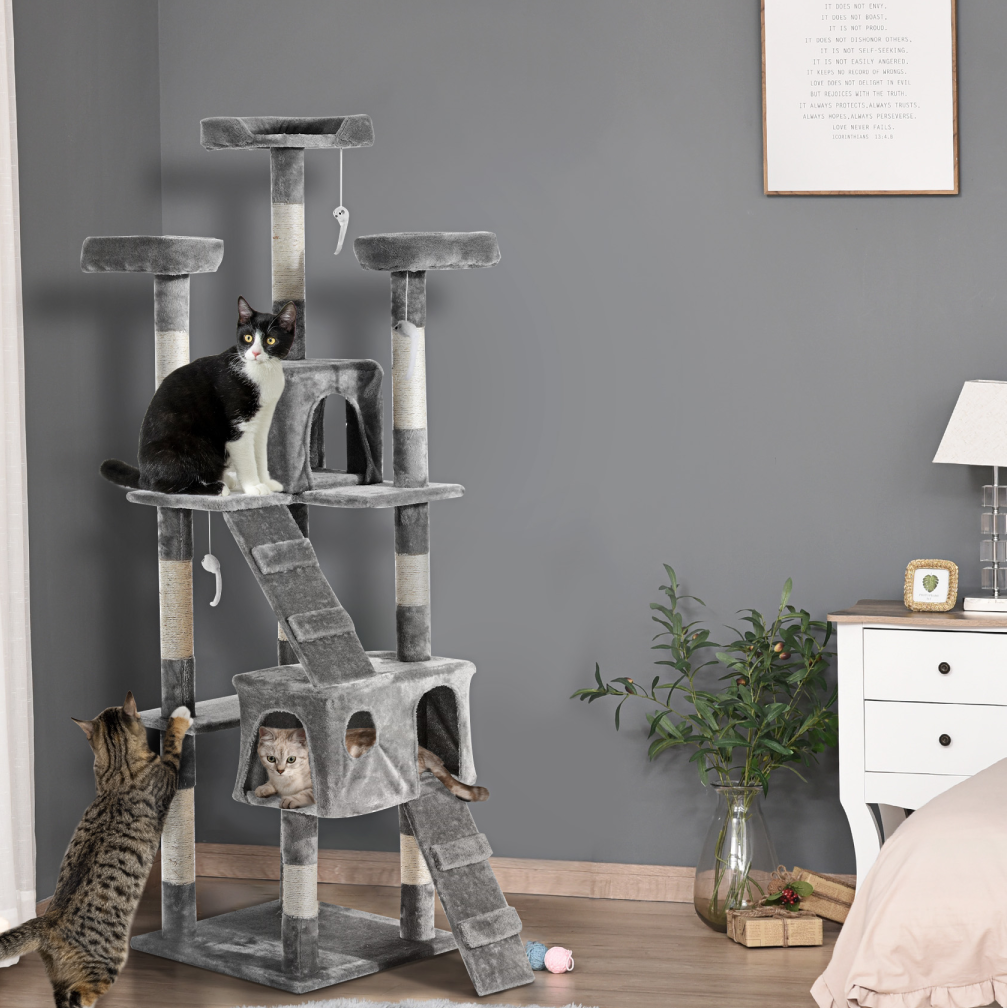 Cat tree with multiple levels in a room with a cat climbing on it.
